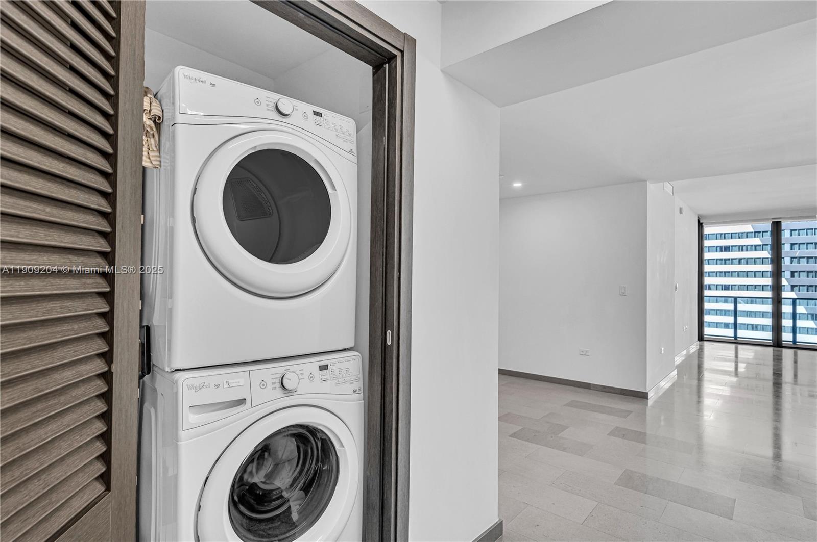 88 Southwest 7th Street, Unit 806 Miami, FL 33130 - Photo 8 of 54 a view of a hallway with washer and dryer
