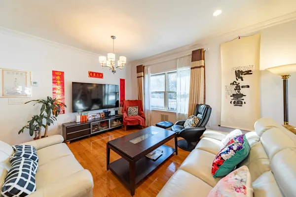 a living room with lots of furniture and a chandelier