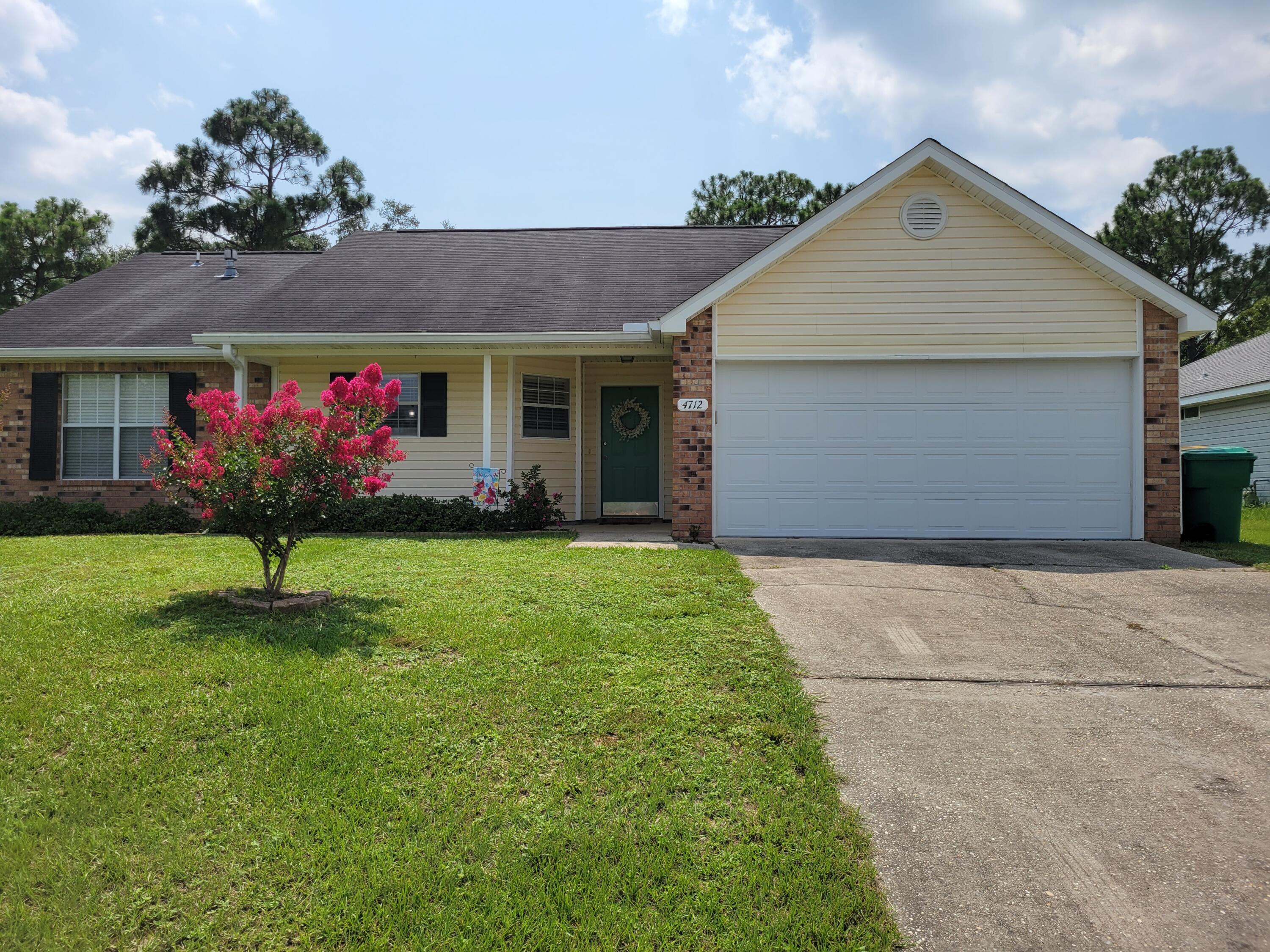 4712 Whitewater Lane Crestview, FL 32539 - Photo 1 of 25 a front view of house with a garden