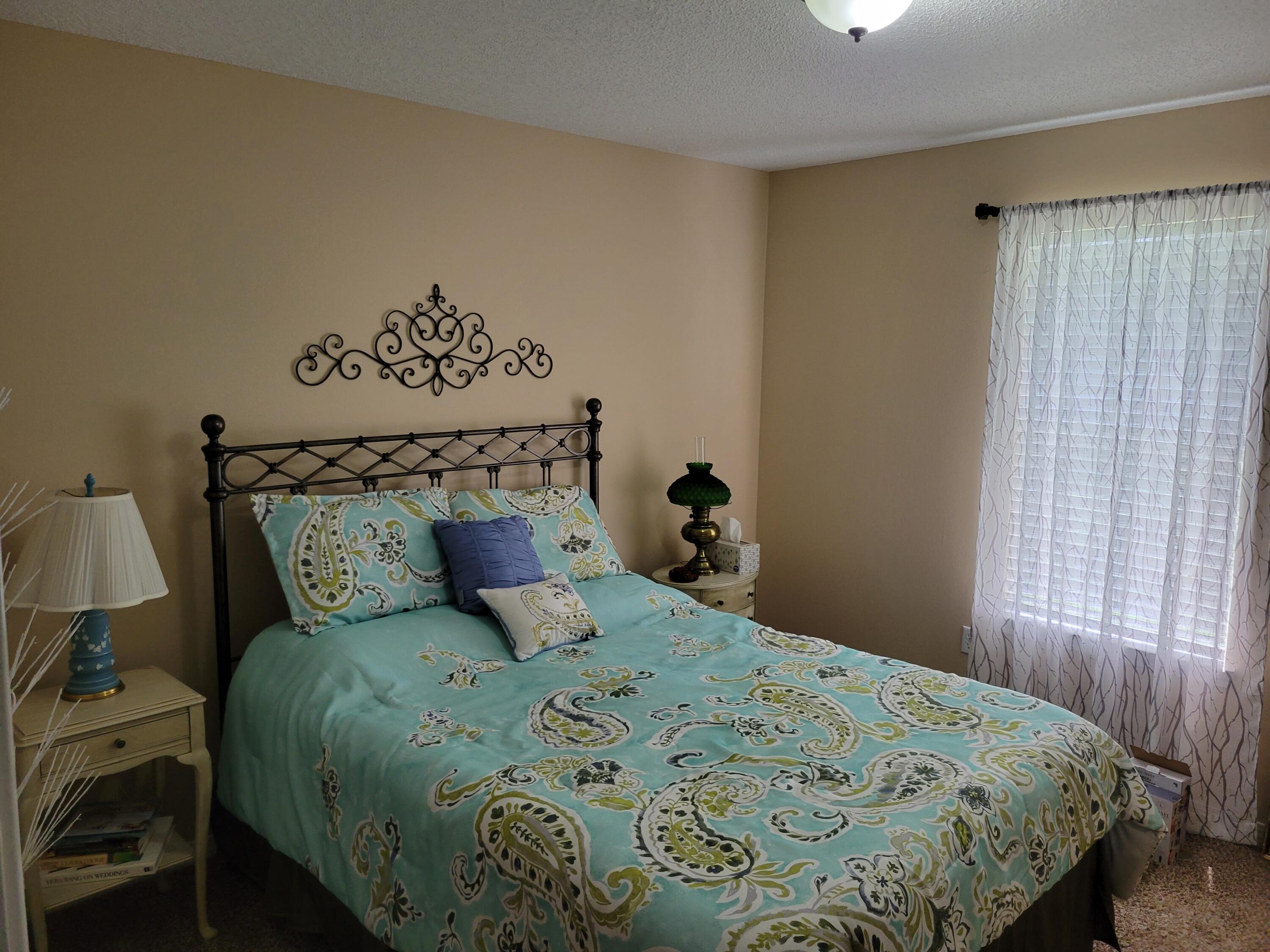 4712 Whitewater Lane Crestview, FL 32539 - Photo 11 of 25 a bedroom with a bed and wooden floor
