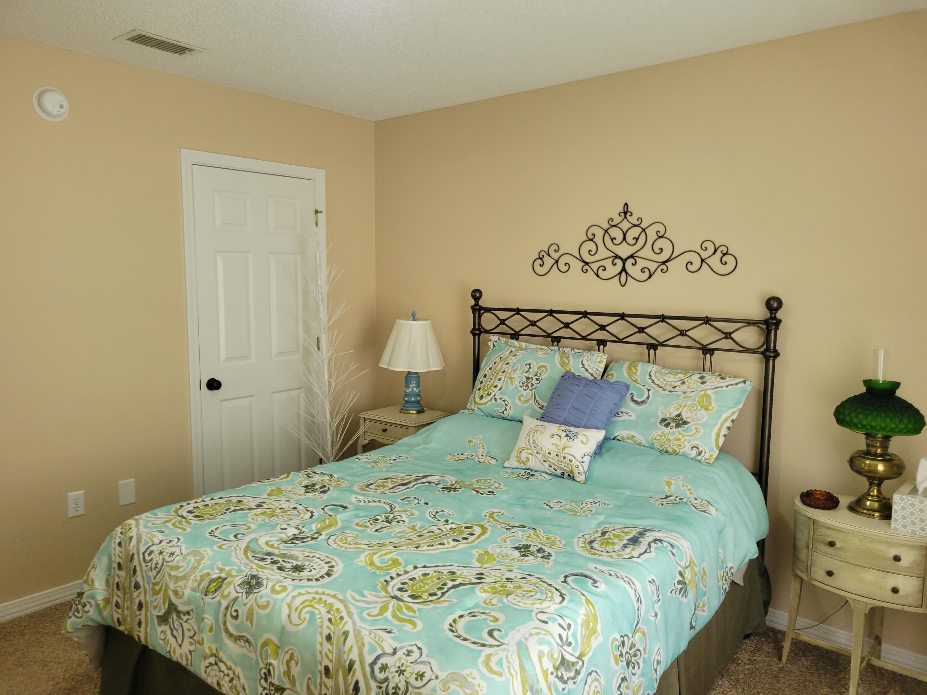4712 Whitewater Lane Crestview, FL 32539 - Photo 12 of 25 a bedroom with a bed and lamps
