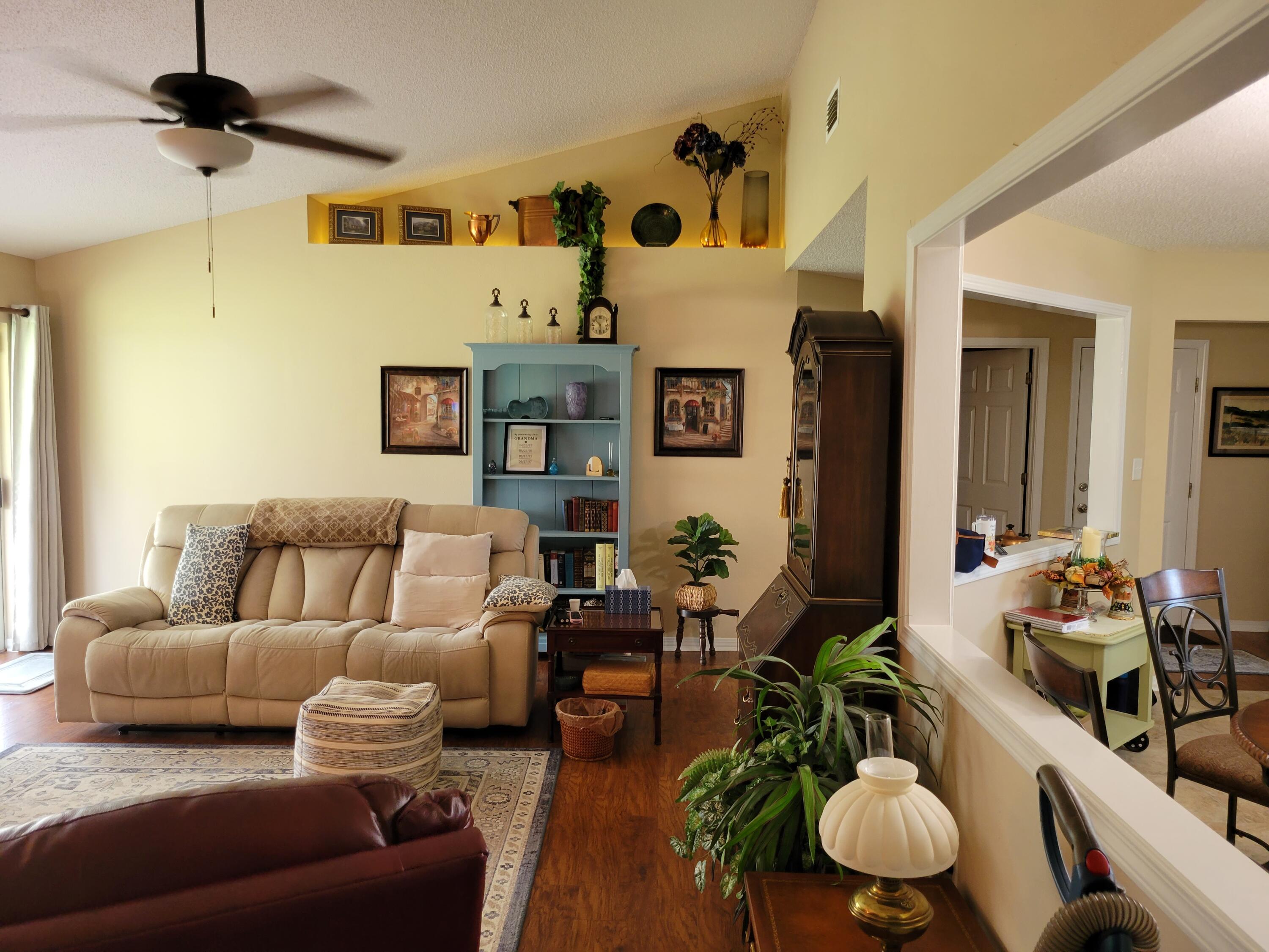 4712 Whitewater Lane Crestview, FL 32539 - Photo 13 of 25 a living room with furniture kitchen view and a chandelier