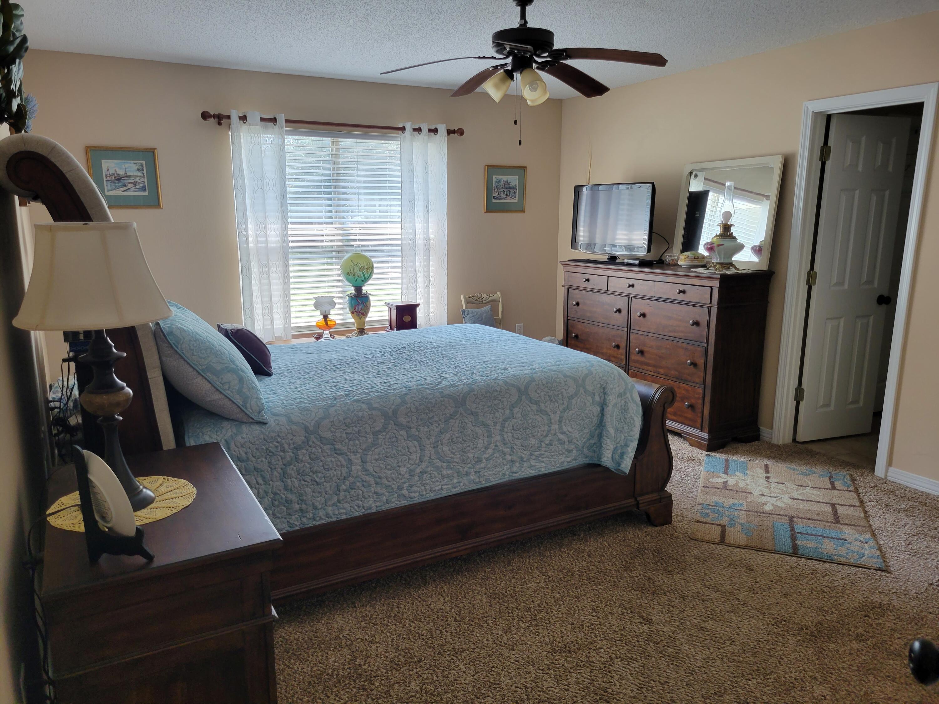 4712 Whitewater Lane Crestview, FL 32539 - Photo 18 of 25 a bedroom with a bed dresser and a window