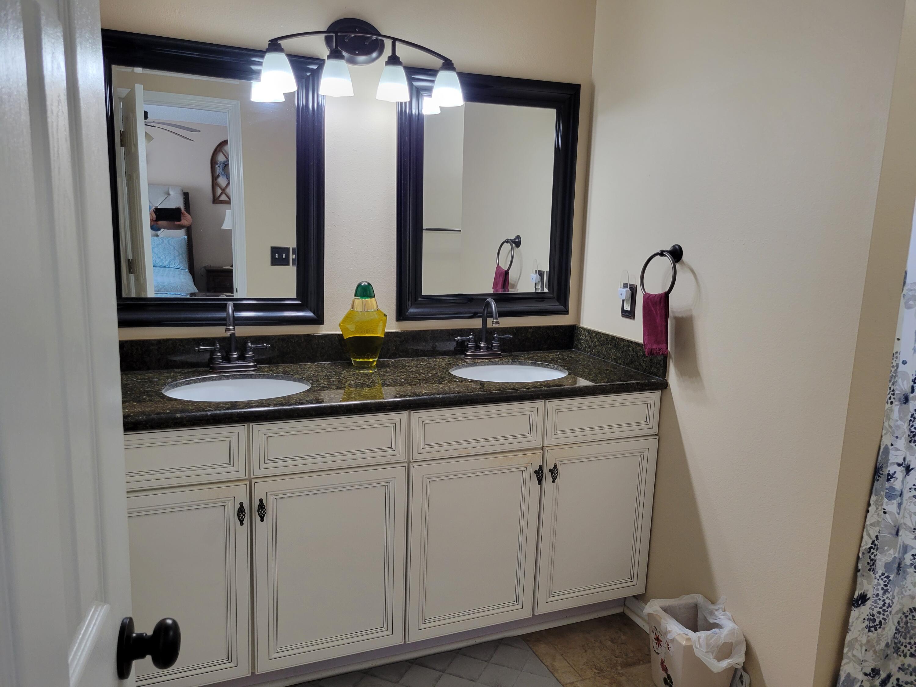 4712 Whitewater Lane Crestview, FL 32539 - Photo 20 of 25 a bathroom with a double vanity sink and a mirror