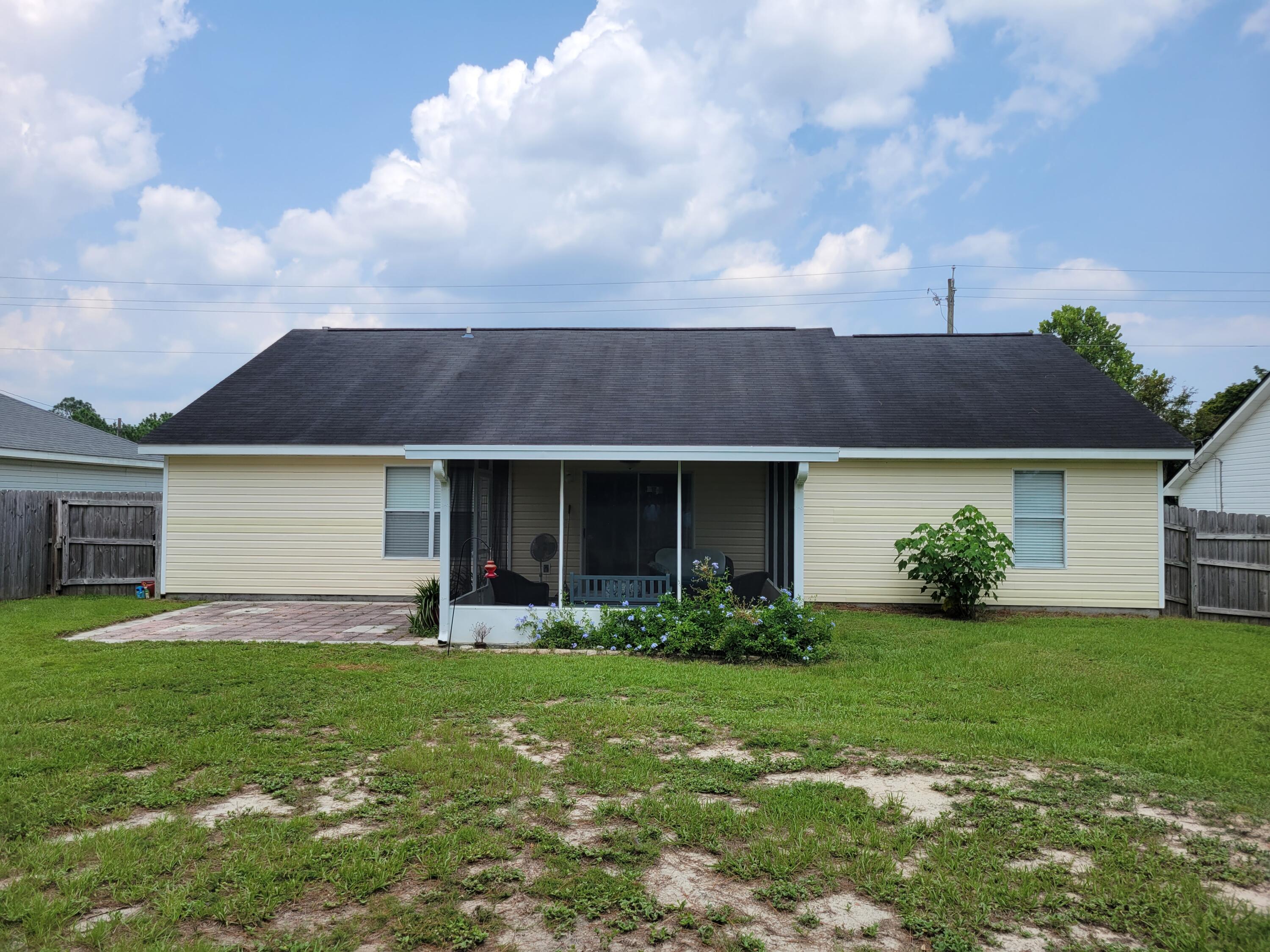 4712 Whitewater Lane Crestview, FL 32539 - Photo 2 of 25 a front view of a house with a yard and garage