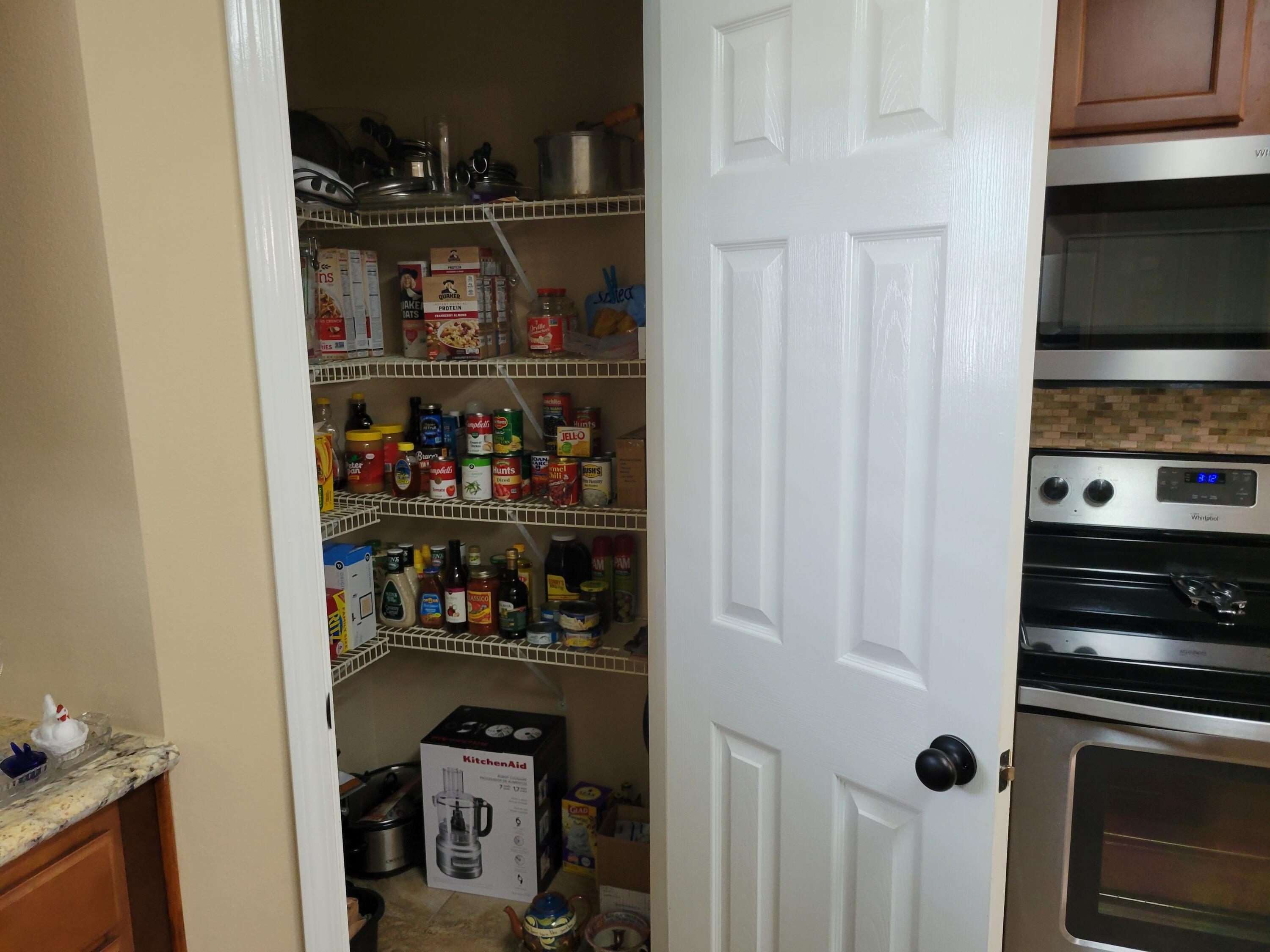 4712 Whitewater Lane Crestview, FL 32539 - Photo 23 of 25 a kitchen with a refrigerator a stove and a microwave