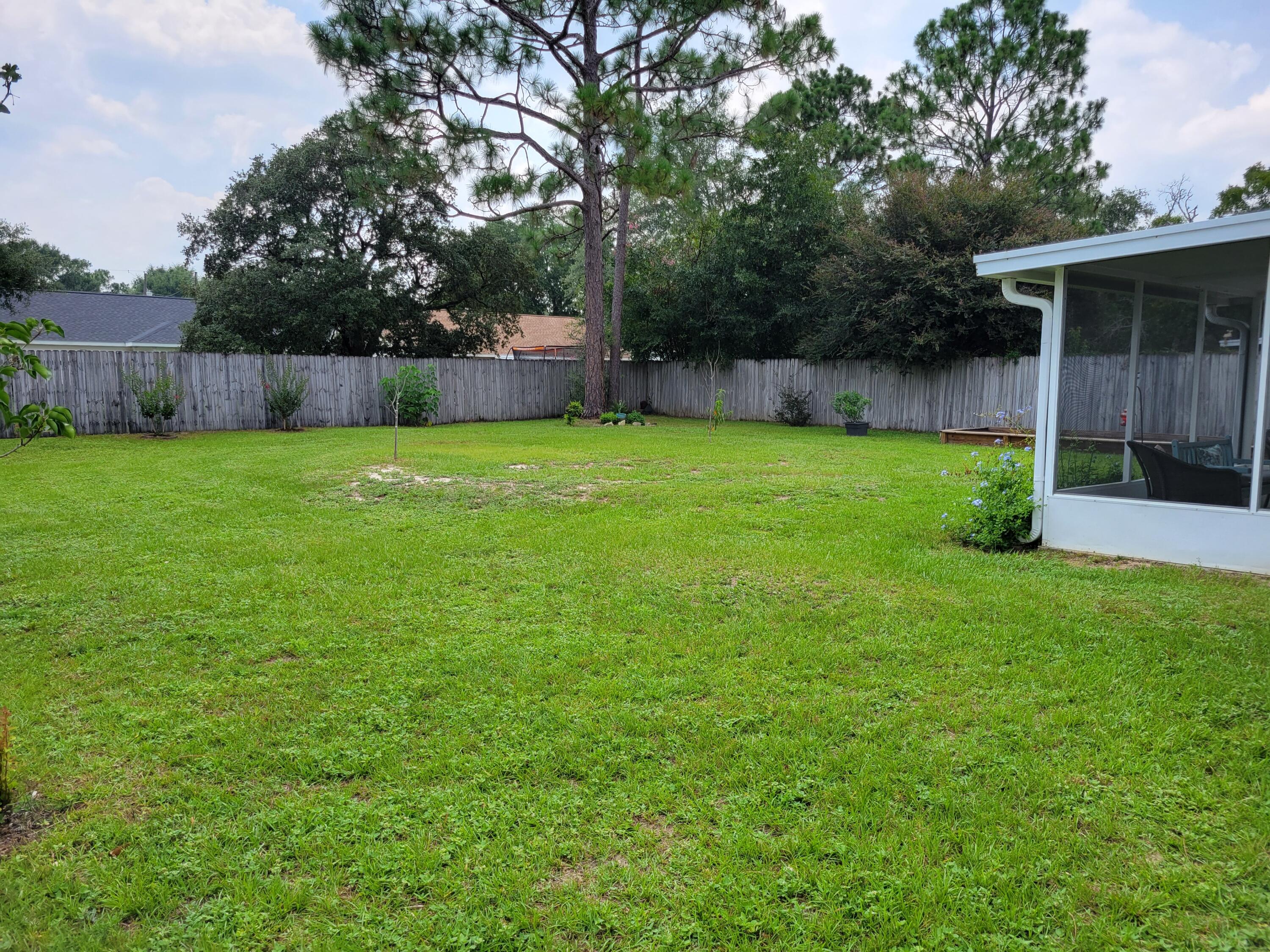 4712 Whitewater Lane Crestview, FL 32539 - Photo 4 of 25 a view of a backyard with a garden