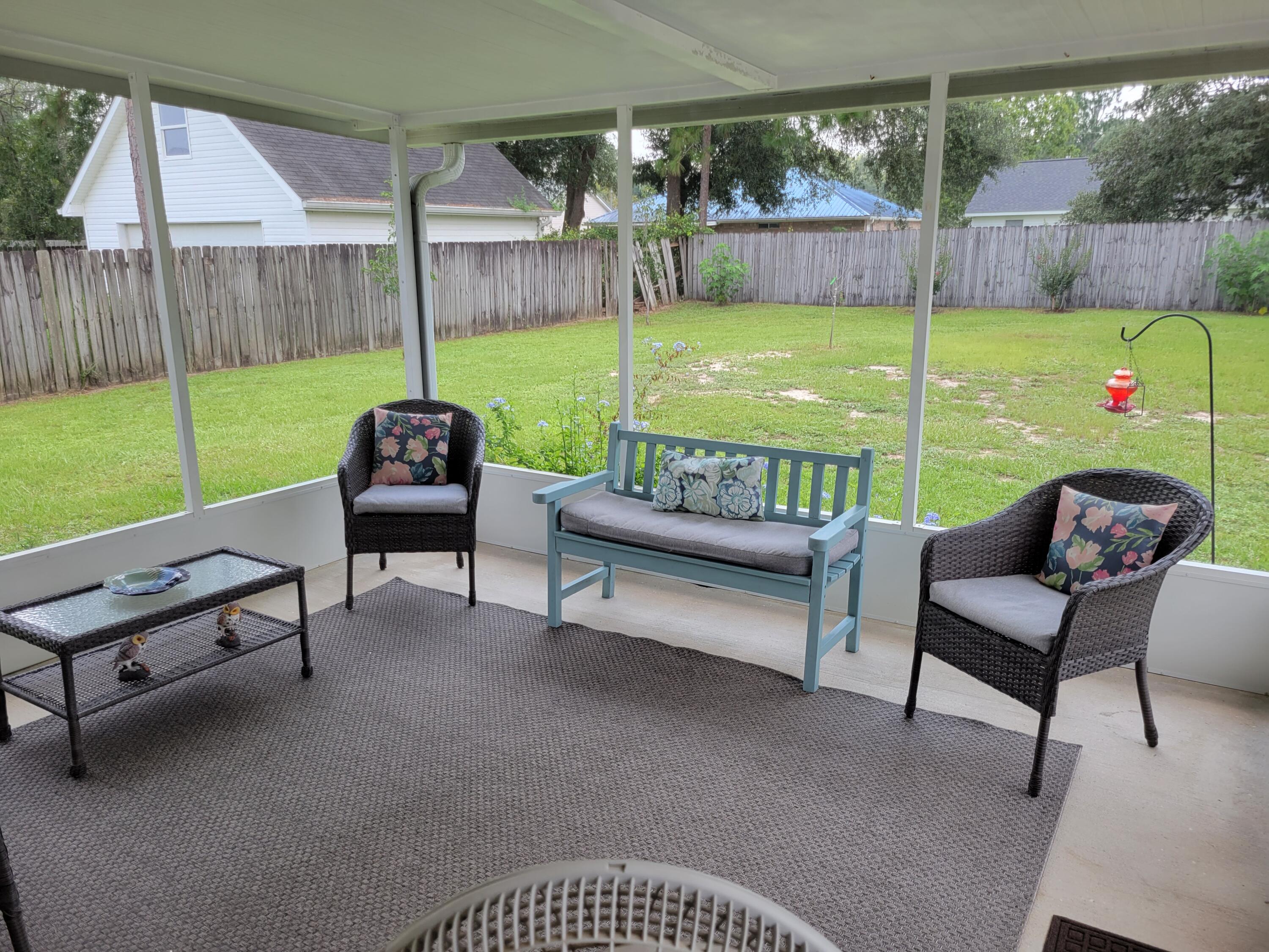 4712 Whitewater Lane Crestview, FL 32539 - Photo 5 of 25 a bench sitting in middle of a yard