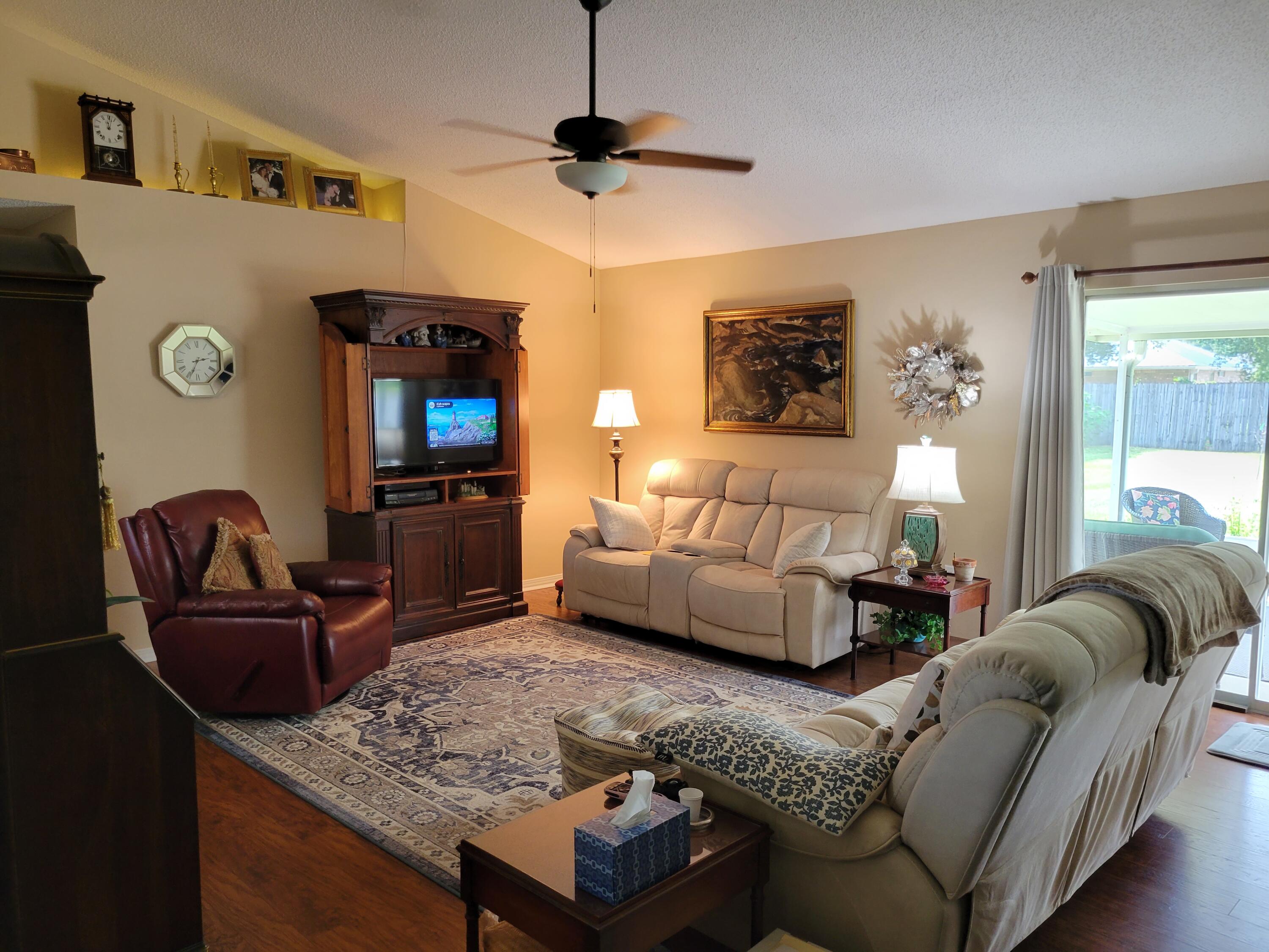 4712 Whitewater Lane Crestview, FL 32539 - Photo 7 of 25 a living room with furniture and a flat screen tv