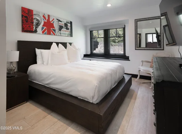 a bedroom with bed and window