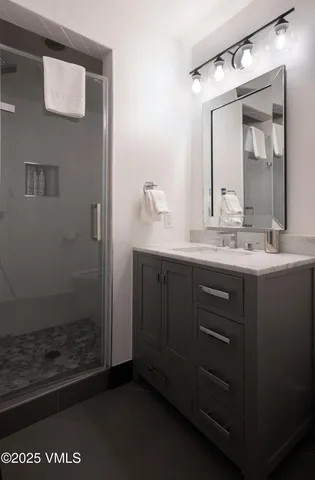 a bathroom with a mirror sink and vanity