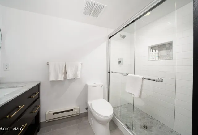 a bathroom with a sink toilet and shower