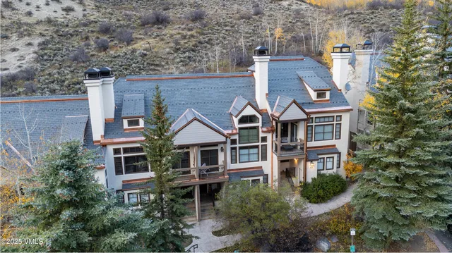 an aerial view of a house with a yard