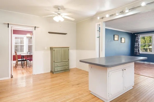 a kitchen with kitchen island a counter top space and a sink cabinets