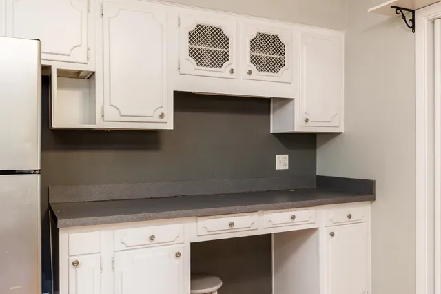 a kitchen with stainless steel appliances white cabinets and a sink