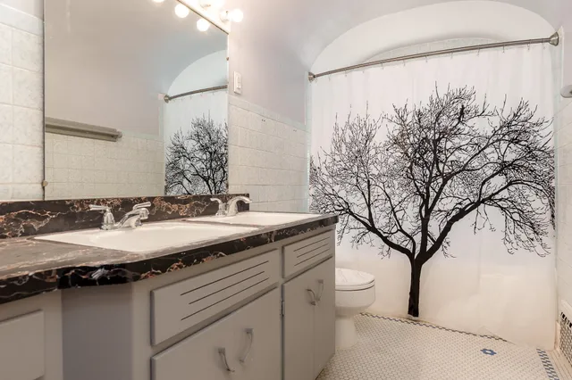 a bathroom with a granite countertop sink and a mirror