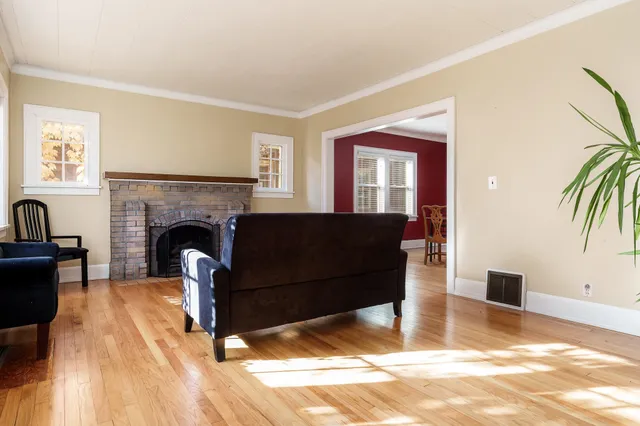 a living room with furniture and a fireplace