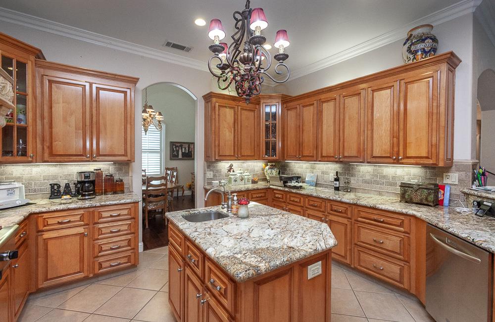 1111 Brighton Way Lodi, CA 95242 - Photo 15 of 87 a kitchen with stainless steel appliances granite countertop a sink dishwasher stove and refrigerator with wooden cabinets