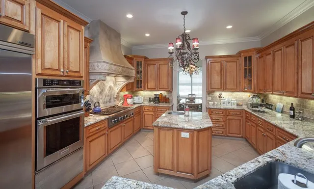 a dining room with wooden floor a chandelier a glass table and chairs