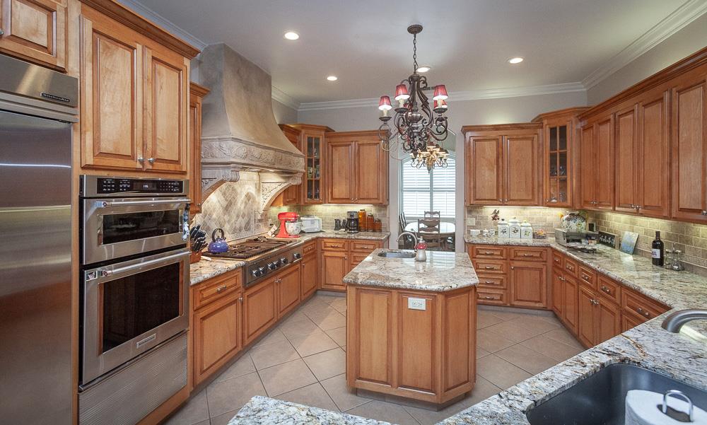 1111 Brighton Way Lodi, CA 95242 - Photo 16 of 87 a kitchen with granite countertop a sink stove and refrigerator