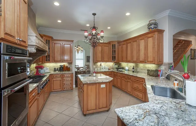 a view of a dining room with furniture and chandelier