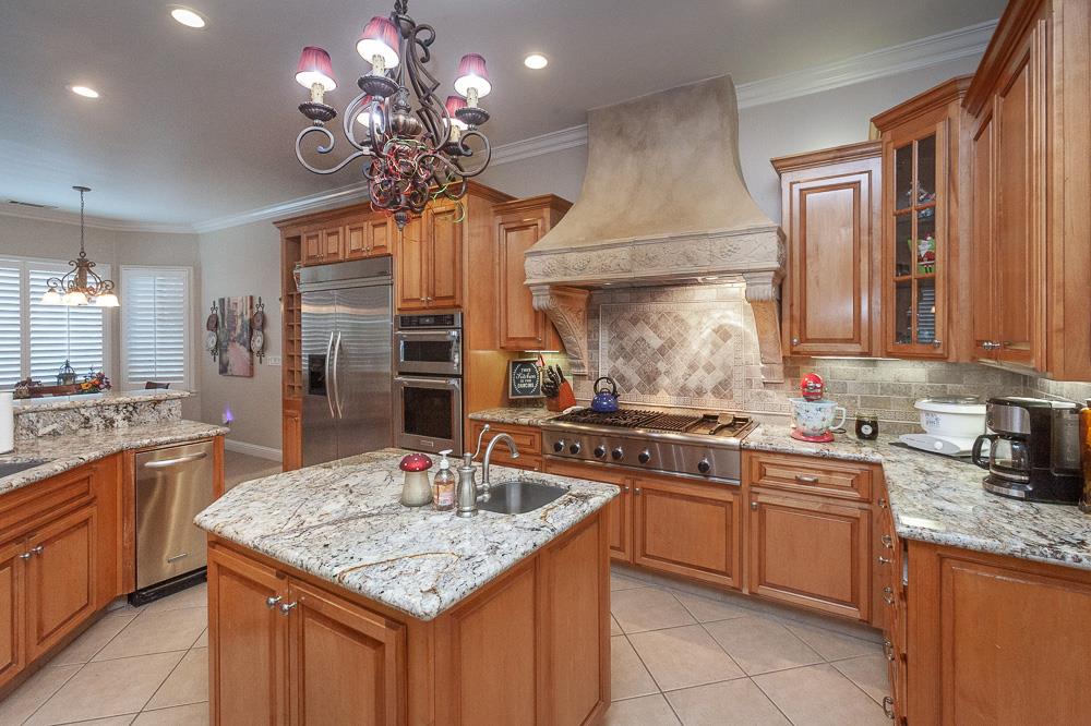 1111 Brighton Way Lodi, CA 95242 - Photo 18 of 87 a kitchen with stainless steel appliances granite countertop a sink stove and refrigerator