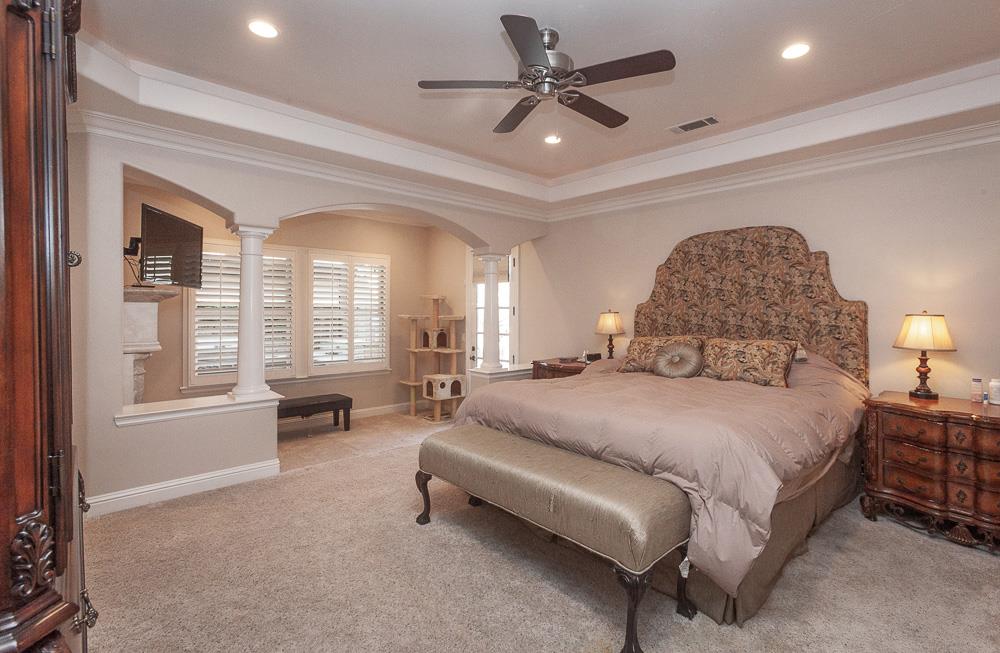 1111 Brighton Way Lodi, CA 95242 - Photo 31 of 87 a spacious bedroom with a bed a couch and a chandelier