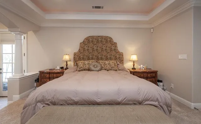 a bed room with a bed and chair