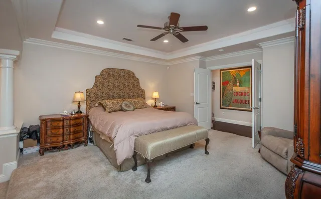 a bed sitting in a bedroom next to a book shelf
