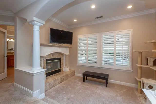 a room with a table chairs and wooden floor
