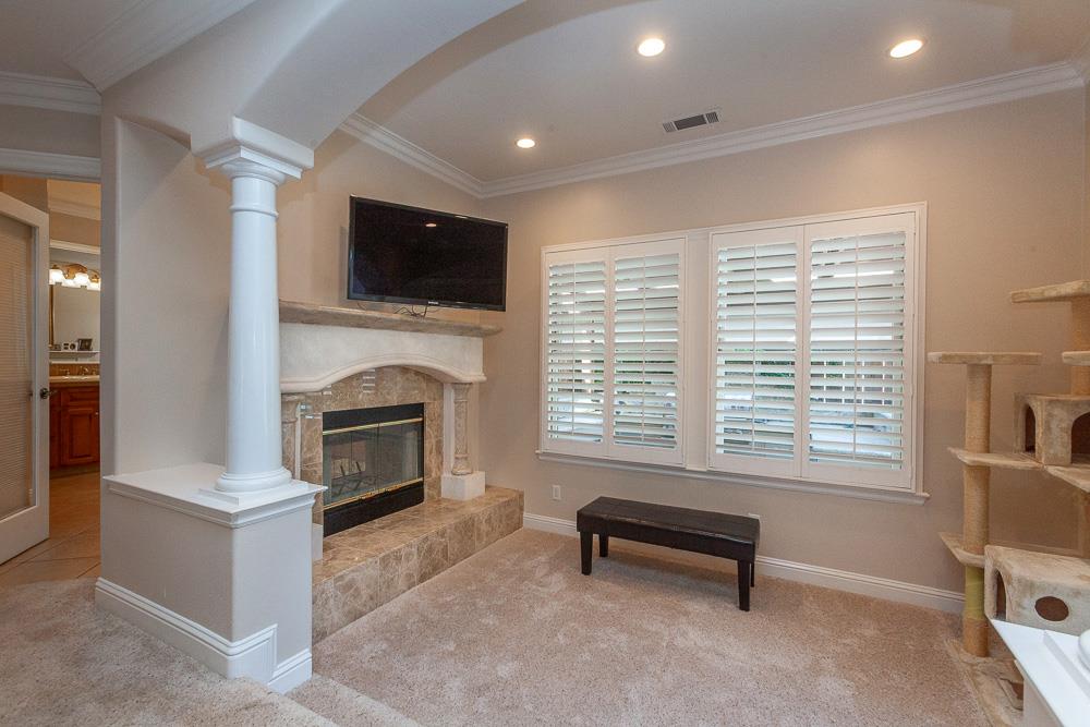 1111 Brighton Way Lodi, CA 95242 - Photo 35 of 87 a living room with furniture a fireplace and a flat screen tv