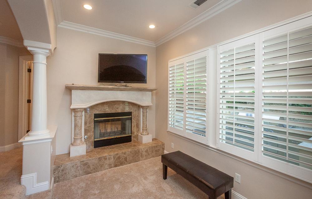 1111 Brighton Way Lodi, CA 95242 - Photo 36 of 87 a living room with a fireplace and a flat screen tv