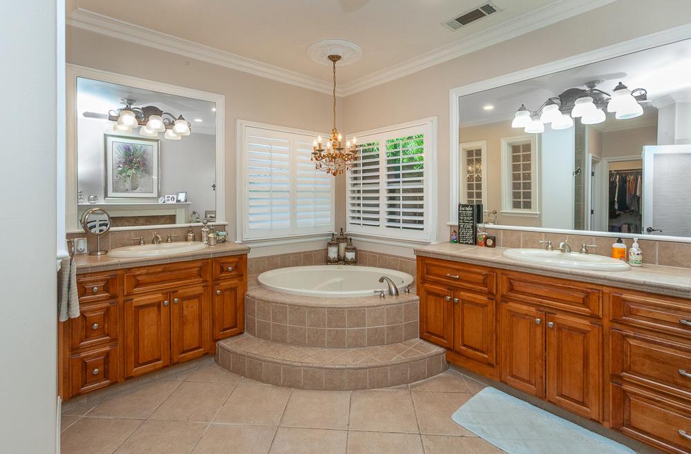 1111 Brighton Way Lodi, CA 95242 - Photo 37 of 87 a spacious bathroom with a granite countertop sink and a bathtub
