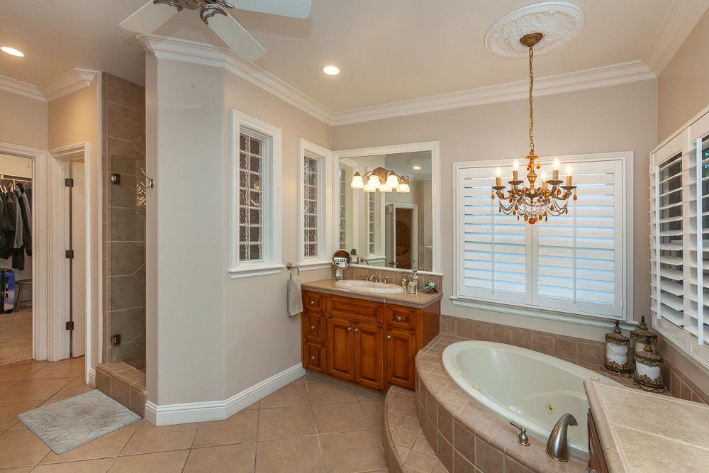 1111 Brighton Way Lodi, CA 95242 - Photo 40 of 87 a spacious bathroom with a tub sink and mirror