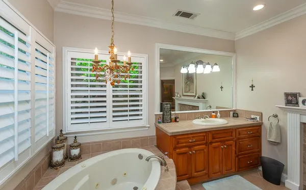 a bathroom with a granite countertop shower a sink and a mirror
