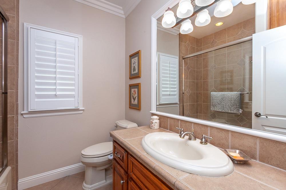 1111 Brighton Way Lodi, CA 95242 - Photo 49 of 87 a bathroom with a sink a toilet and a mirror
