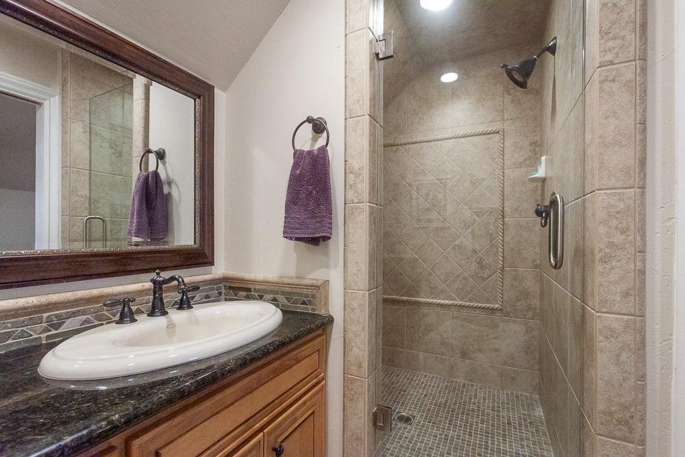 1111 Brighton Way Lodi, CA 95242 - Photo 67 of 87 a bathroom with a granite countertop shower a sink and a mirror