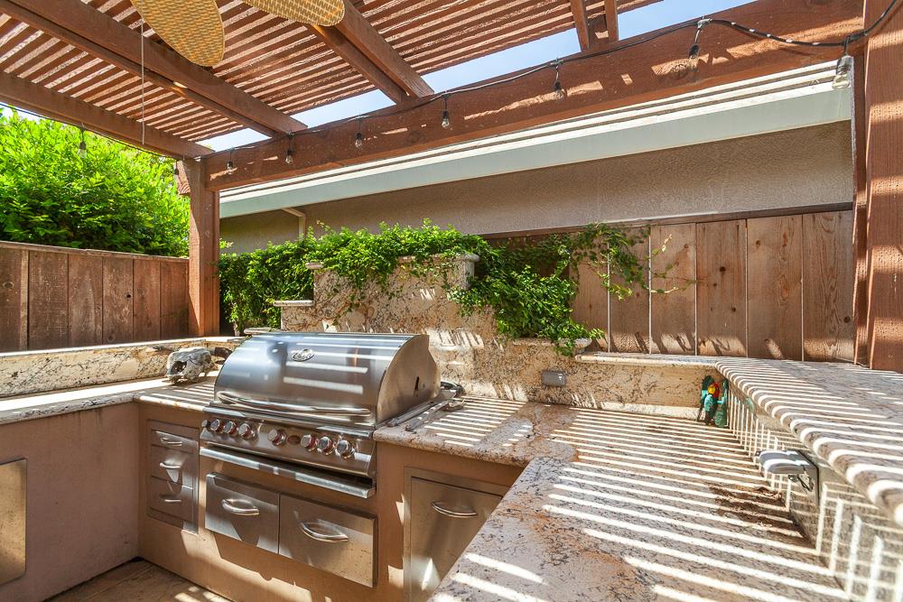 1111 Brighton Way Lodi, CA 95242 - Photo 85 of 87 a view of a patio with table and chairs with wooden floor and fence