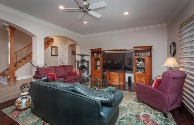 a kitchen with stainless steel appliances granite countertop a sink dishwasher stove and refrigerator with wooden cabinets