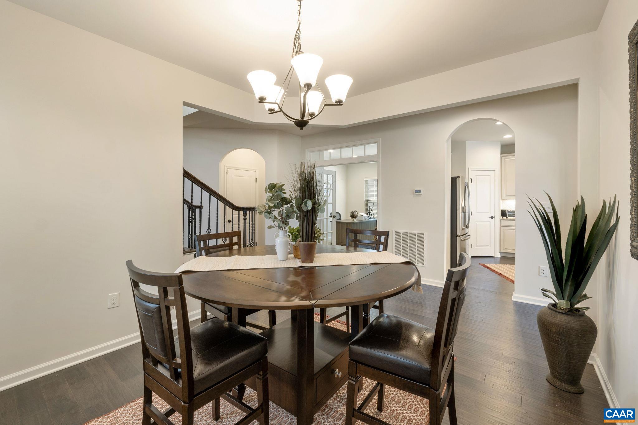 1516 Delphi Lane Charlottesville, VA 22911 - Photo 24 of 74 a view of a dining room with furniture and a chandelier