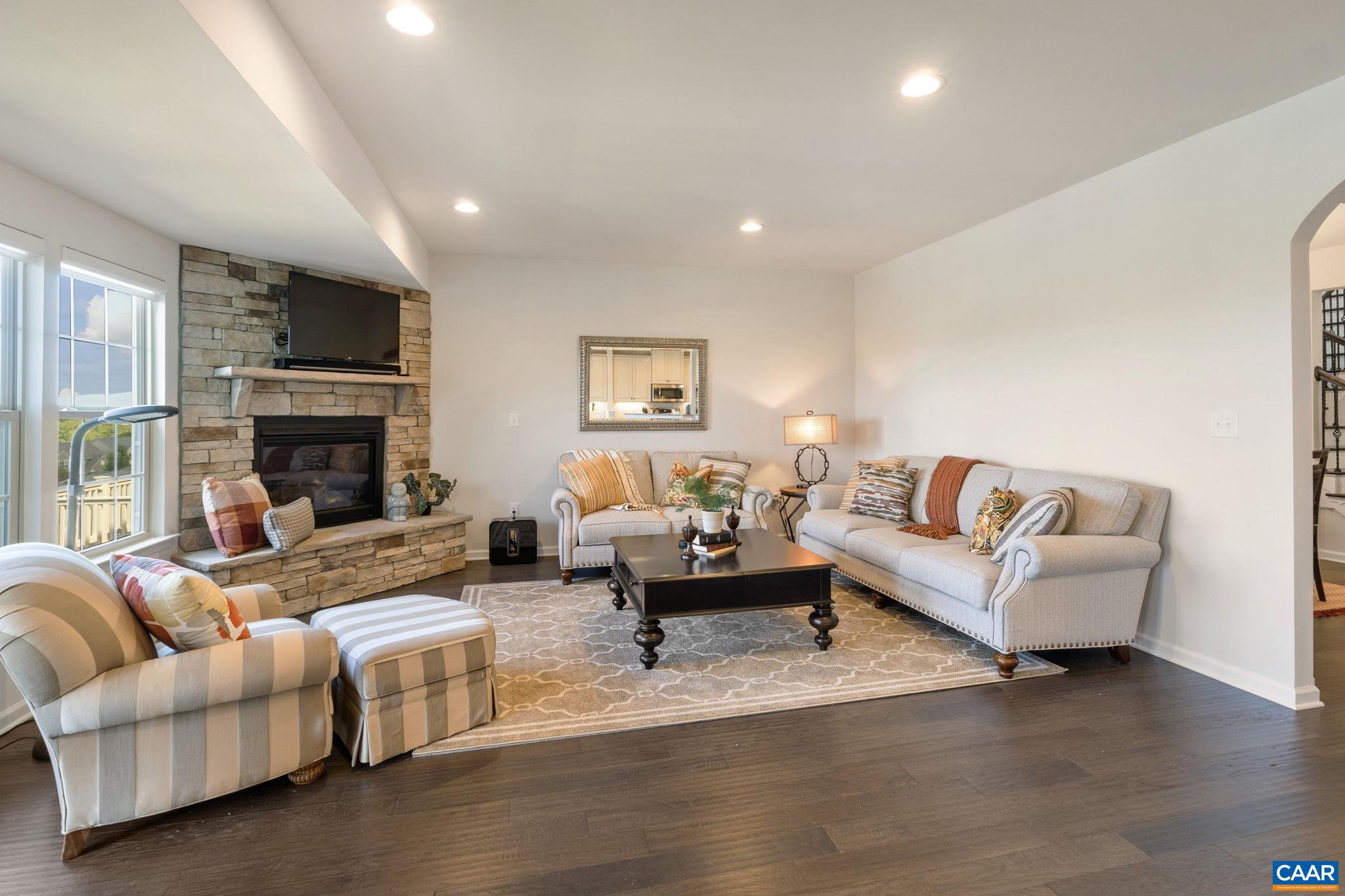 1516 Delphi Lane Charlottesville, VA 22911 - Photo 27 of 74 a living room with fireplace furniture and a flat screen tv