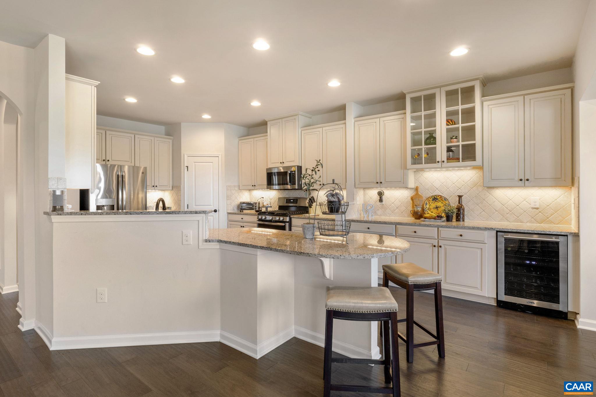 1516 Delphi Lane Charlottesville, VA 22911 - Photo 30 of 74 a kitchen with stainless steel appliances granite countertop a stove top oven a sink dishwasher a refrigerator and white cabinets with wooden floor