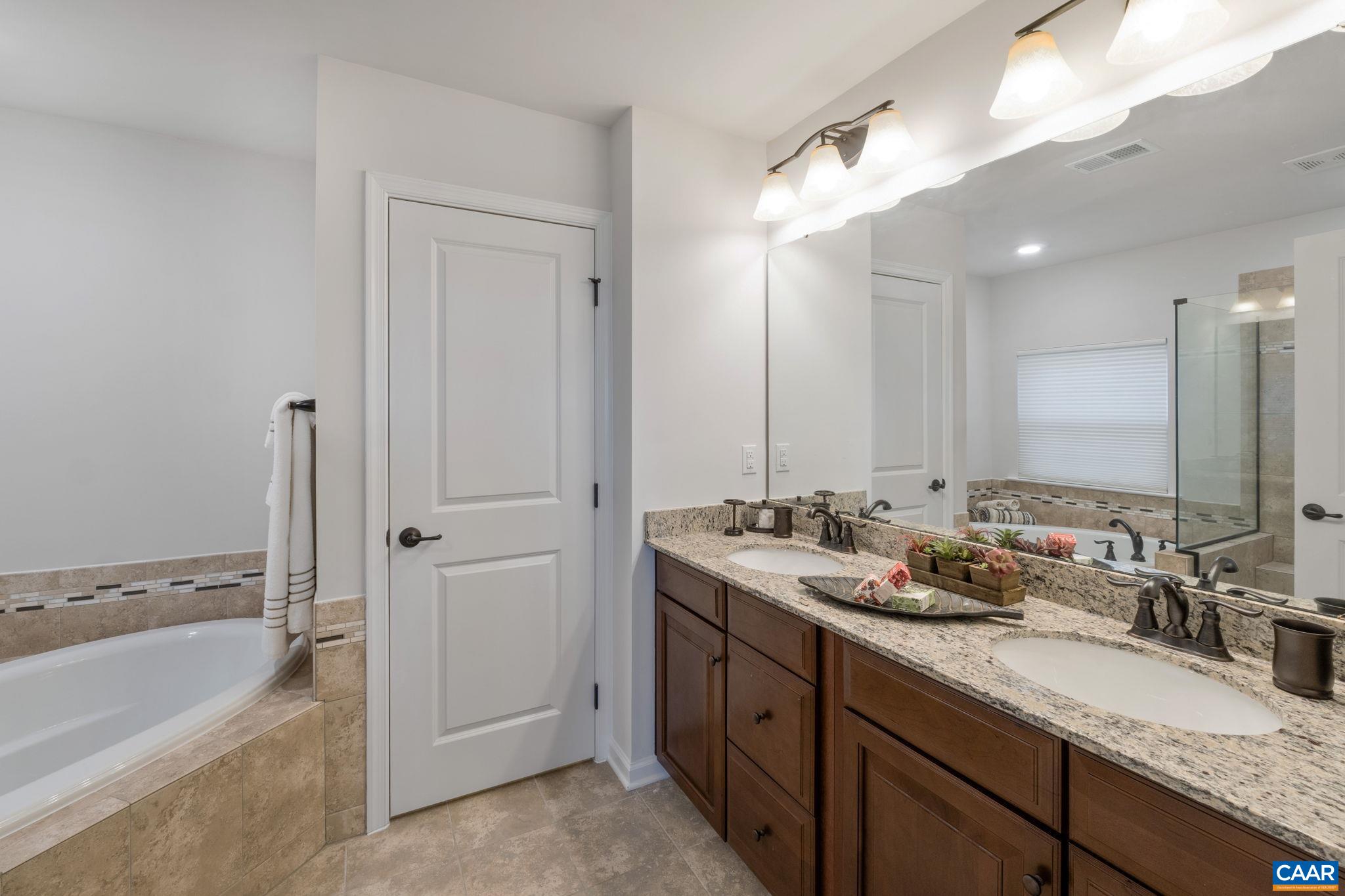1516 Delphi Lane Charlottesville, VA 22911 - Photo 42 of 74 a bathroom with a granite countertop sink mirror and a bathtub