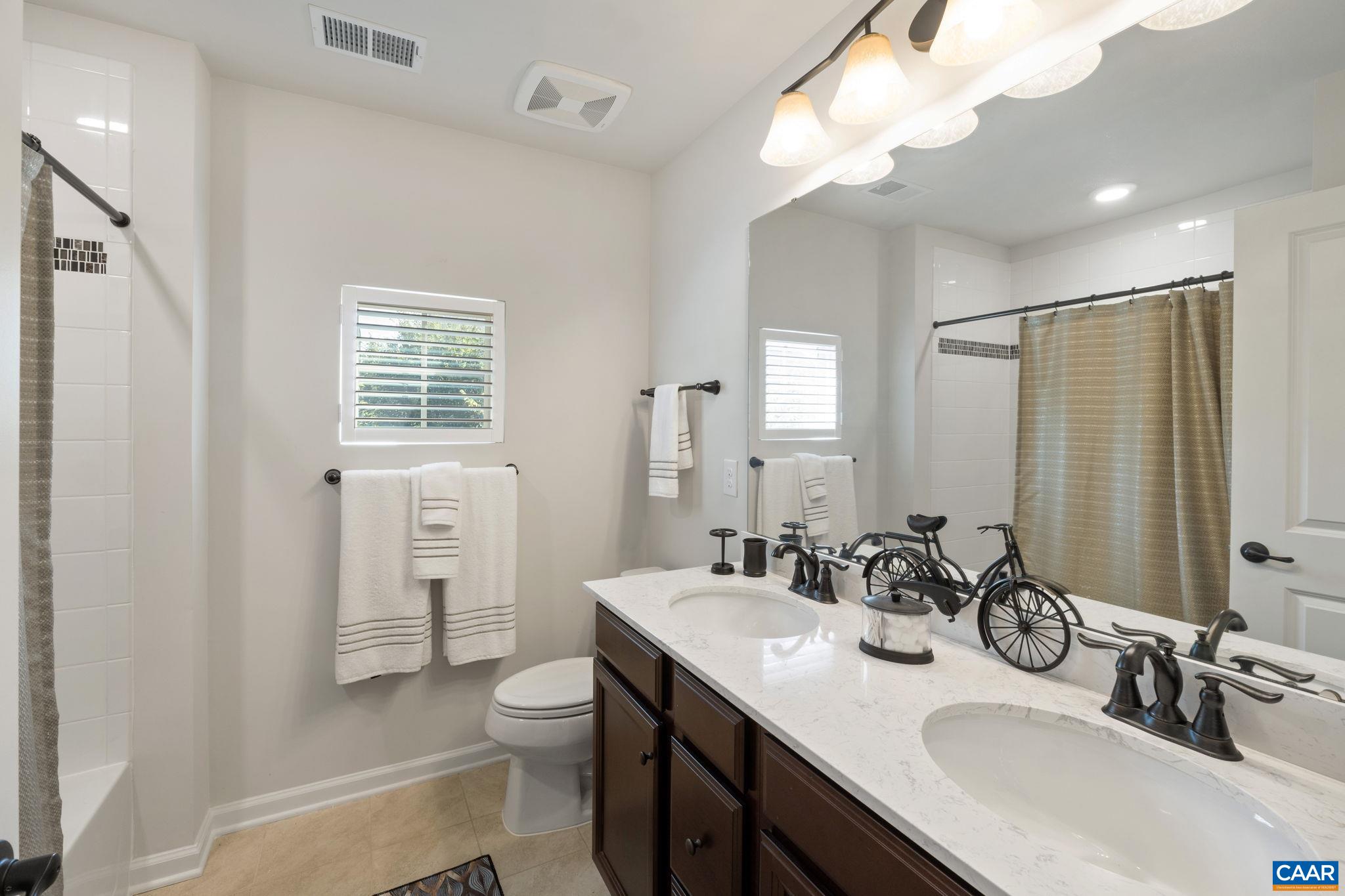 1516 Delphi Lane Charlottesville, VA 22911 - Photo 47 of 74 a bathroom with double vanity sink a mirror and a toilet