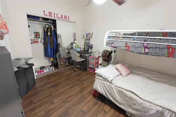 a bedroom with bed and wooden floor