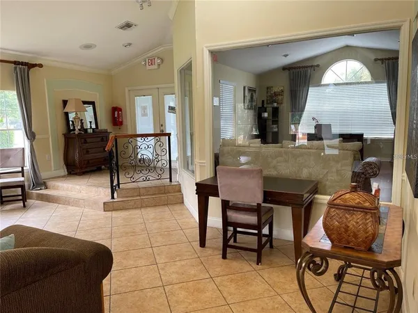 a living room with furniture and a painting on the wall