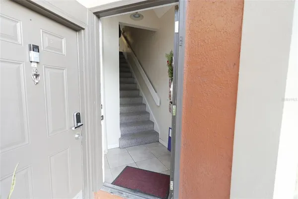 a view of a hallway with wooden floor and entryway