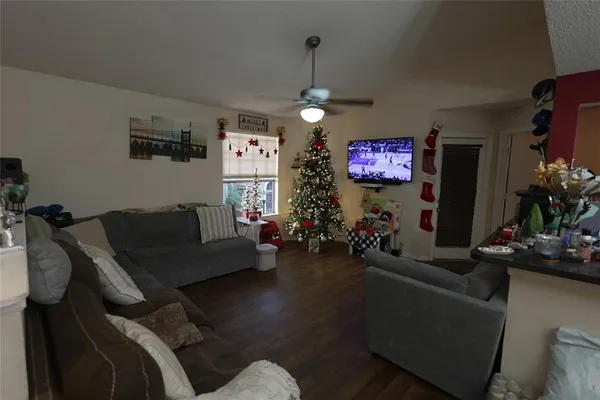 a living room with furniture and a chandelier