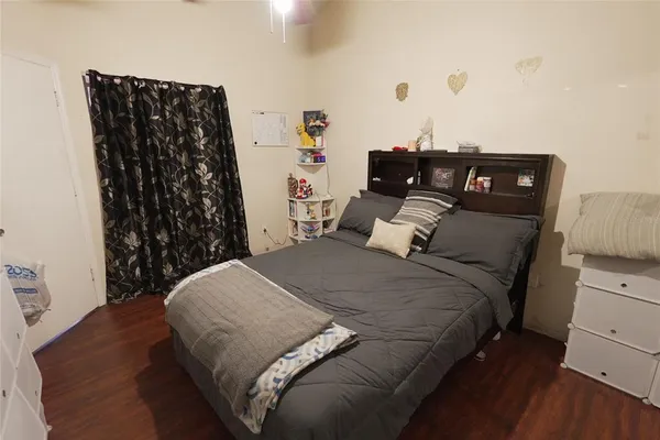 a bedroom with a bed and a night stand