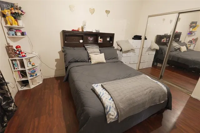 a bed sitting in a bedroom next to a window